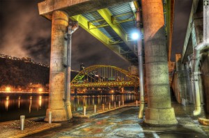 Fort Pitt Bridge framed by the pillars of the Mon Wharf reflected into the night-time waters of the Monongahela River, Pittsburgh PA, January 12, 2012, Photo by Glen Green